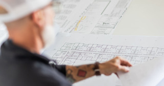 Contractor reviewing architectural plans