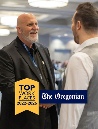 Team members smiling and Top Workplaces Logo