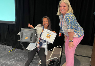 Woman receiving sponsor prize and YETI cooler from woman