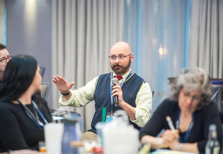 Male attendee speaking to the room