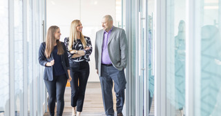 Guardian employees discussing in a hallway