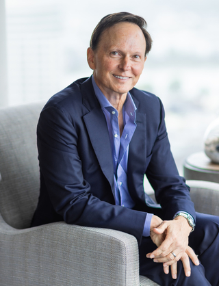 Tom Brenneke sitting and smiling