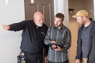 Maintenance crew looking at iPad and pointing
