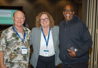 Group of three individuals posing for photo