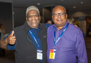 Professionals posing for photo with thumbs up