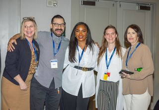 Group of professionals posing for photo