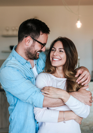 Couple embracing and smiling