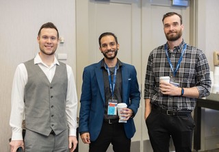Group of three professionals posing for picture
