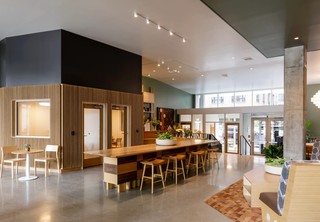 Beautiful open lobby with large table and work cubbies