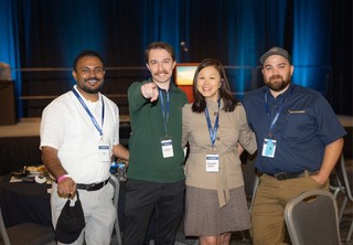 A group of four people smiling at the camera