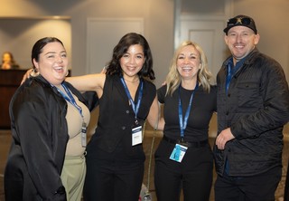 A group of four people smiling at the camera