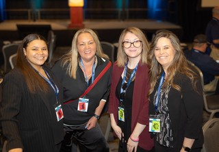 Four professional ladies smiling at the camera