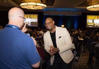 Keynote speaker Jacob Brown interacting with an audience member