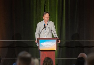 President Tom Brenneke speaking on stage