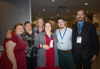 A large group dressed up and posing for the camera