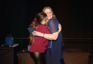 Two women hugging and celebrating