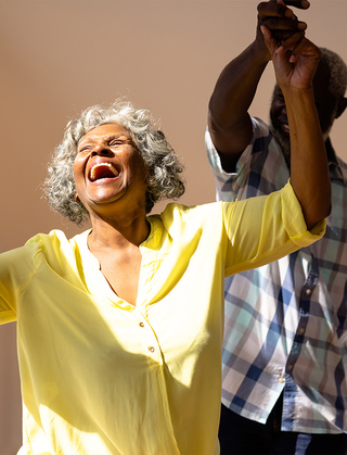 Senior couple laughing and dancing together