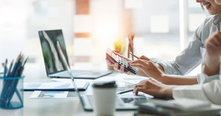 People reviewing numbers with calculator