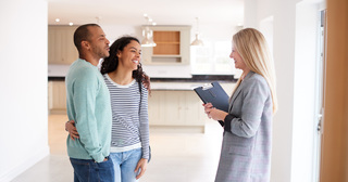 Couple touring apartment with community manager