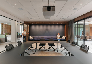 Large conference room with large windows to open office areas