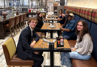 Couple celebrating with group behind them