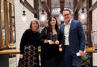 Baylee posing with Josh and Melody