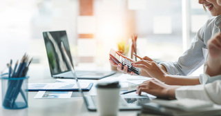 People reviewing numbers with calculator