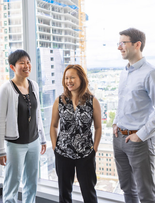 Team members walking down hallway while talking